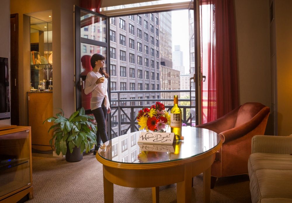 woman looking out of balcony of a suite