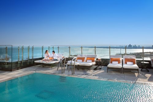 Couple Poolside with views of Lake Ontario